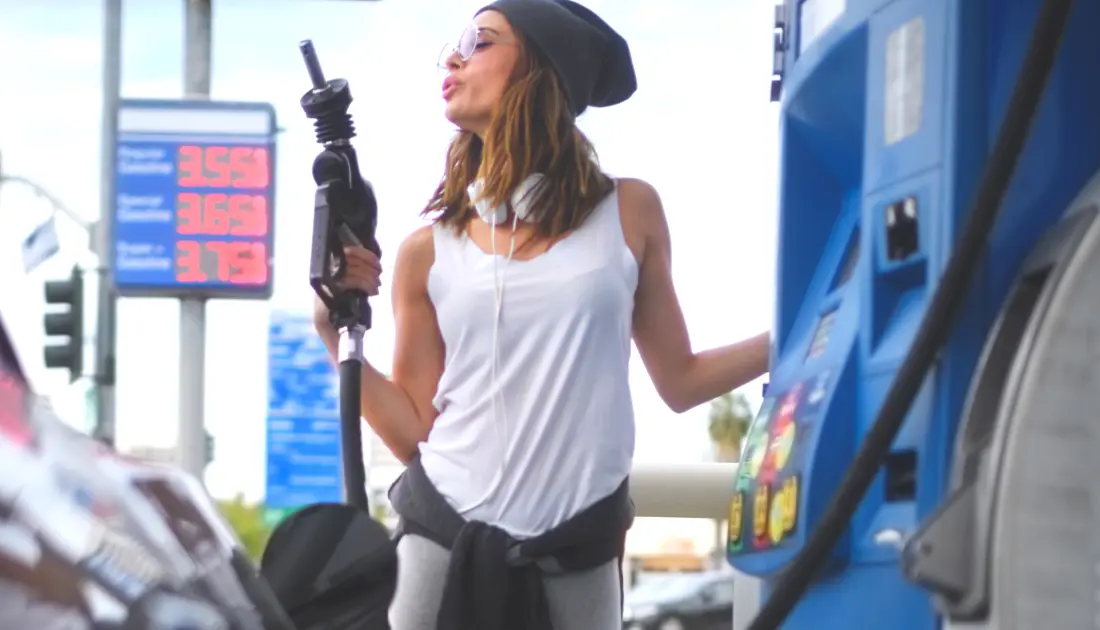 woman holding gas pump
